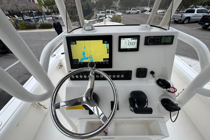 Slide: The Image of 2024 Key West 250 Bay Reef boat dashboard with navigation and control systems. - 15