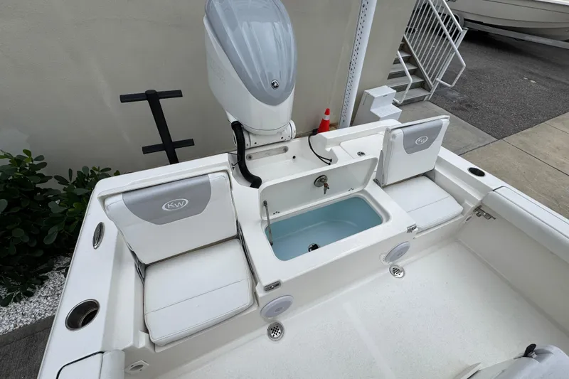 Slide: The Image of 2024 Key West 250 Bay Reef boat interior with seating and storage compartments. - 20
