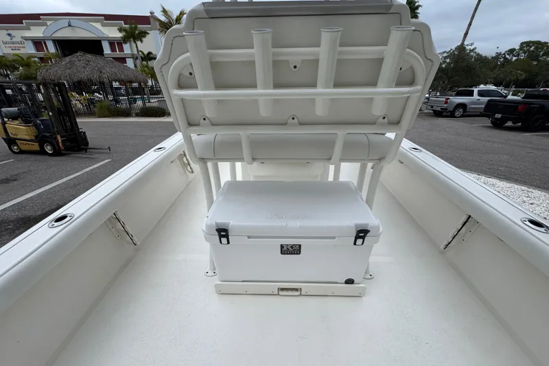 Slide: The Image of 2024 Key West 250 Bay Reef boat interior with cooler and seating arrangement. - 21