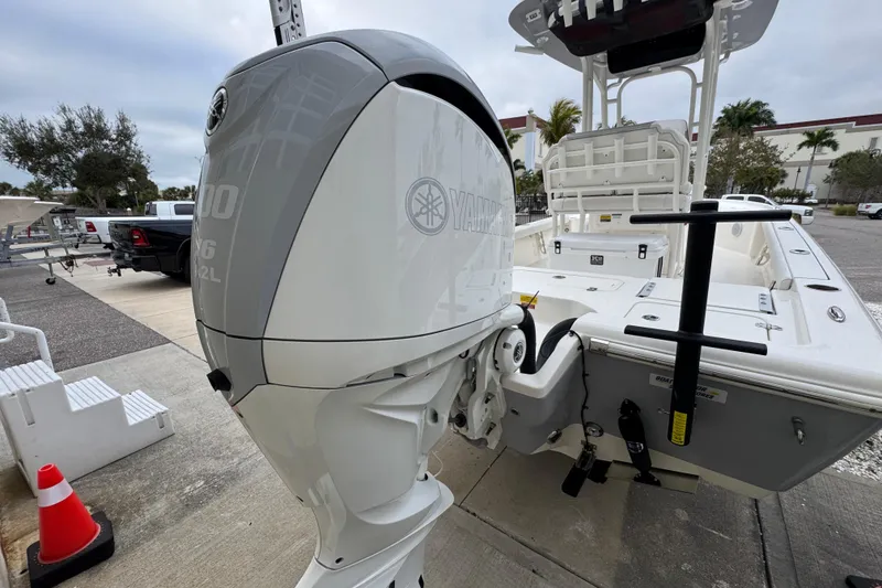 Slide: The Image of 2024 Key West 250 Bay Reef boat with Yamaha outboard motor, parked outdoors. - 23