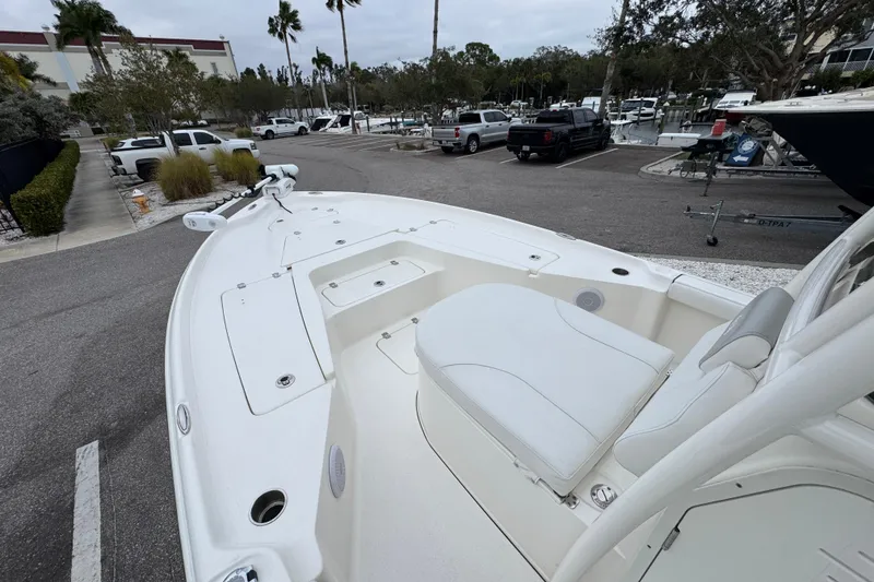 Slide: The Image of 2024 Key West 250 Bay Reef boat in a marina parking lot, showcasing spacious deck. - 3