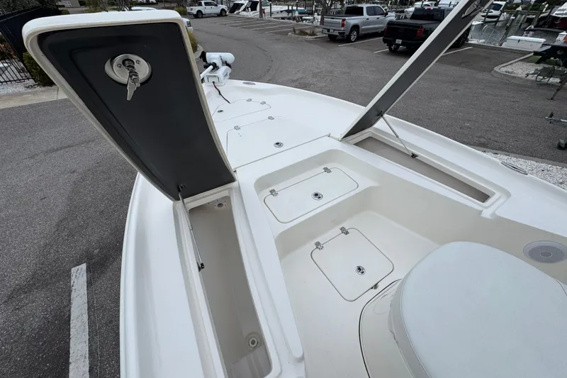 Slide: The Image of 2024 Key West 250 Bay Reef boat with open storage compartments and sleek design. - 5
