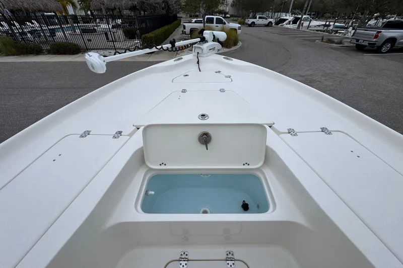 Slide: The Image of 2024 Key West 250 Bay Reef boat deck with storage compartments and trolling motor. - 6