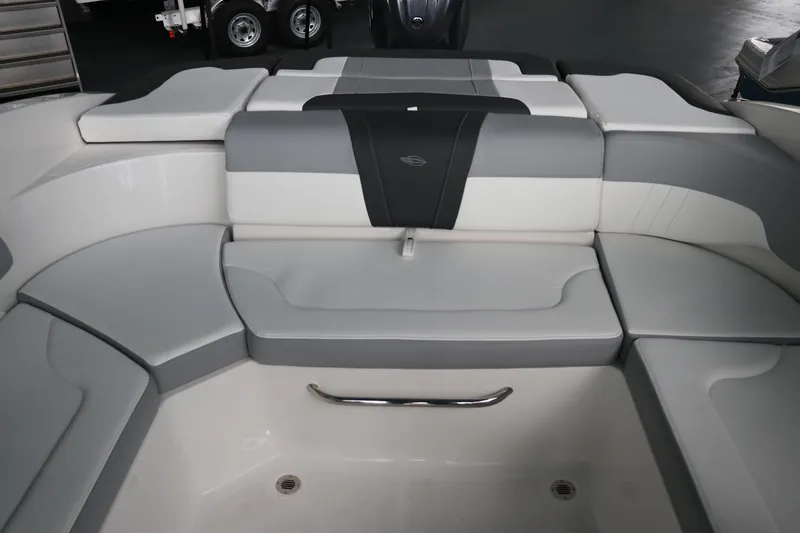 Slide: The Image of 2026 Chaparral 23 SSi OB boat interior with gray and white cushioned seating. - 18