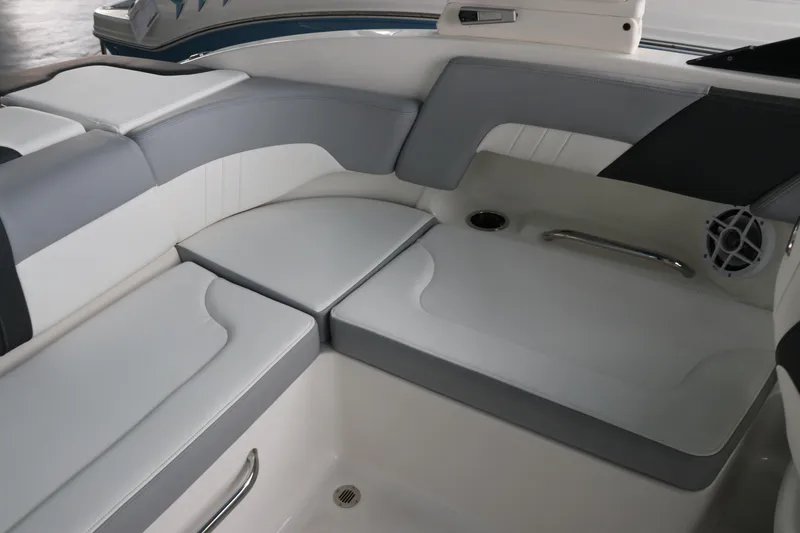 Slide: The Image of 2026 Chaparral 23 SSi OB boat interior with gray and white seating, cup holder, and speaker. - 26