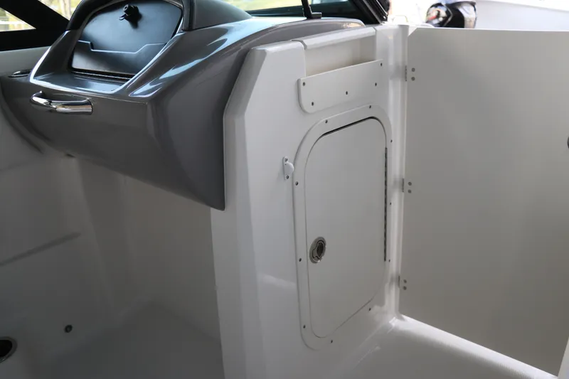 Slide: The Image of 2026 Chaparral 23 SSi OB boat interior with storage compartment and sleek dashboard design. - 32