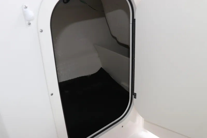 Slide: The Image of Open storage compartment in 2026 Chaparral 23 SSi OB boat. - 33