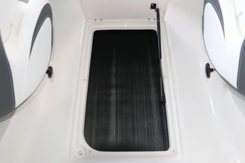 Slide: The Image of 2026 Chaparral 23 SSi OB boat interior storage compartment with black mat. - 35