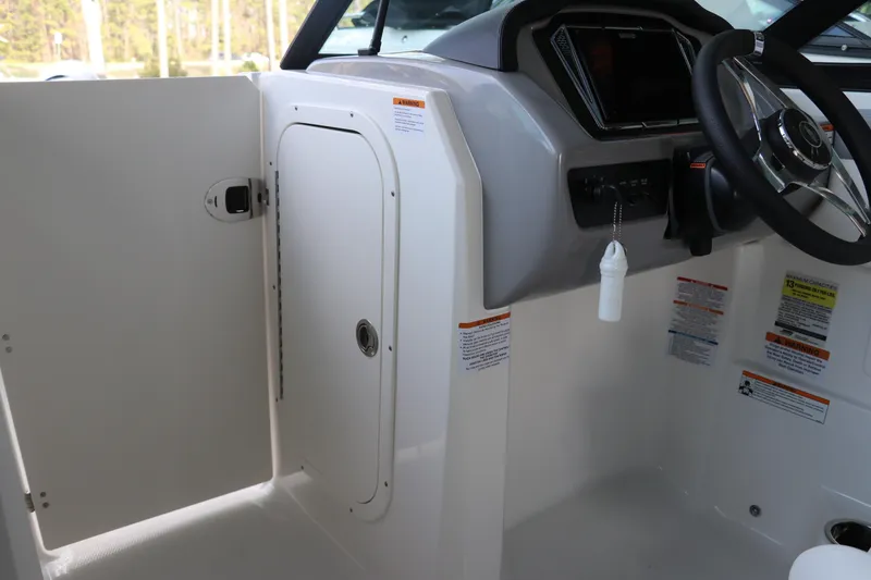 Slide: The Image of 2026 Chaparral 23 SSi OB boat interior with steering wheel and storage compartment. - 36