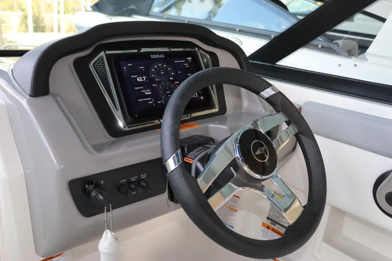 Slide: The Image of 2026 Chaparral 23 SSi OB boat dashboard with steering wheel and digital display. - 38