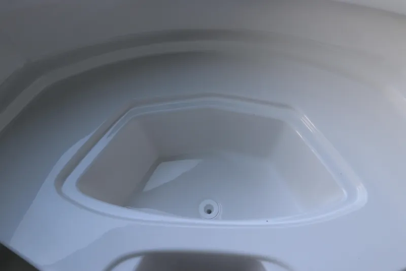 Slide: The Image of 2026 Chaparral 23 SSi OB boat storage compartment, white interior detail. - 43
