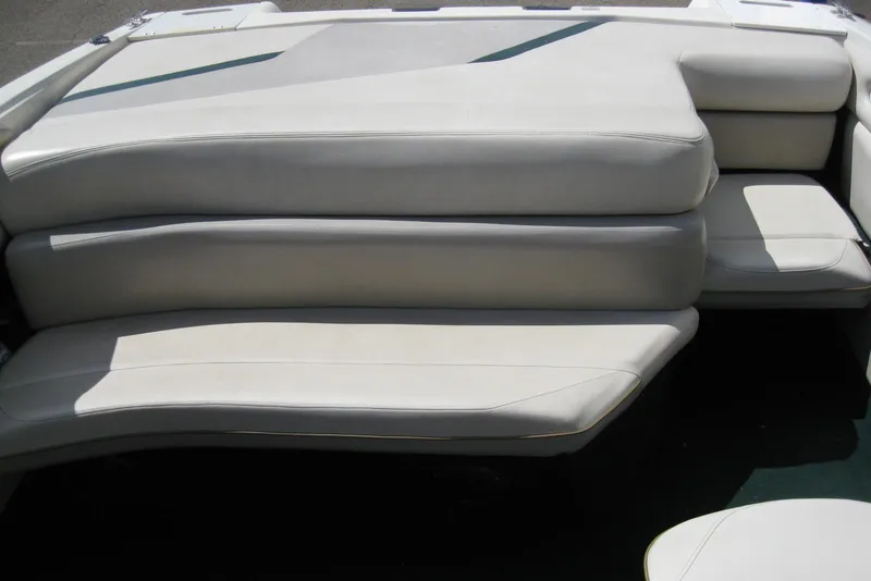 Slide: The Image of 1997 Regal 2100 LSR boat interior seating, featuring white cushioned seats. - 10