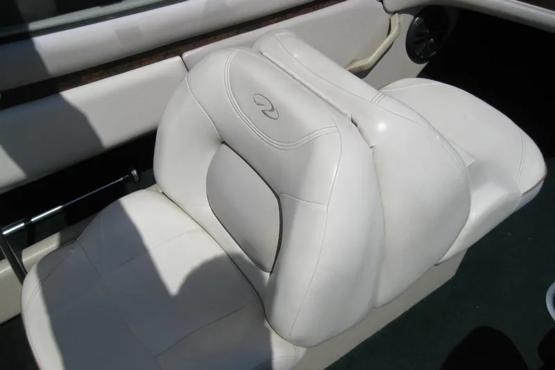 Slide: The Image of White leather seat in a 1997 Regal 2100 LSR boat interior. - 11