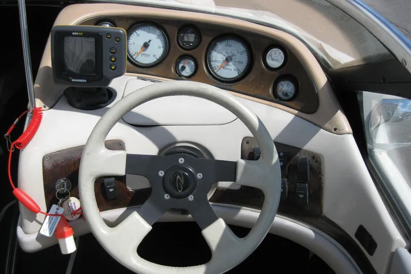 Slide: The Image of Steering wheel and dashboard of a 1997 Regal 2100 LSR boat. - 14