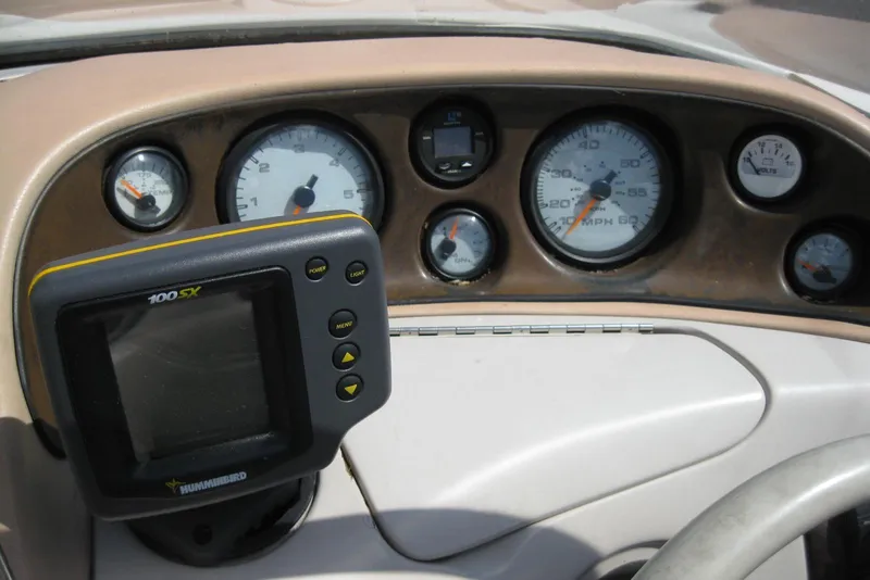 Slide: The Image of Dashboard of a 1997 Regal 2100 LSR boat with gauges and a Humminbird 100SX device. - 15