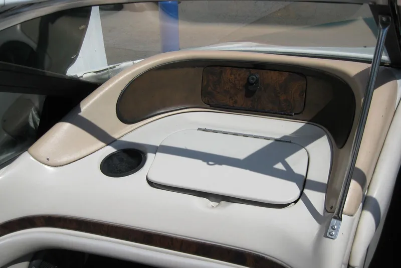 Slide: The Image of 1997 Regal 2100 LSR boat interior dashboard with wood accents and storage compartment. - 16
