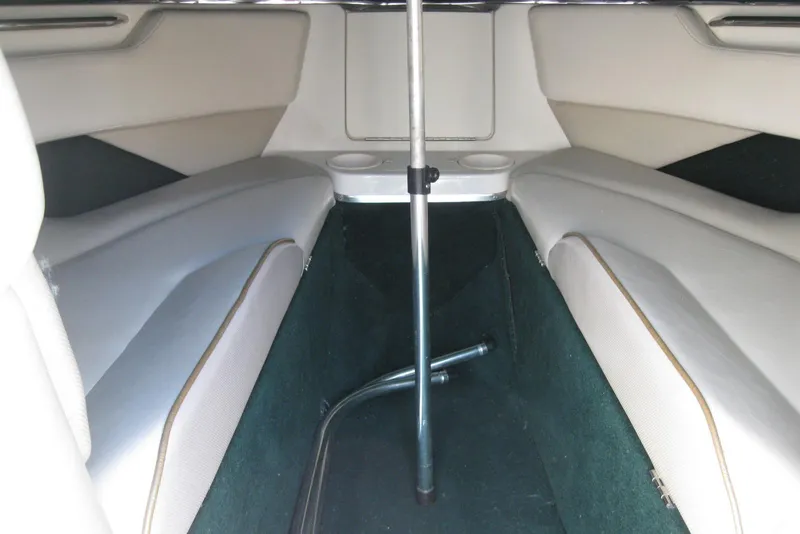 Slide: The Image of Interior of a 1997 Regal 2100 LSR boat, featuring seating and storage area. - 17