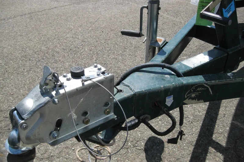 Slide: The Image of Trailer hitch of a 1997 Regal 2100 LSR boat on pavement. - 19