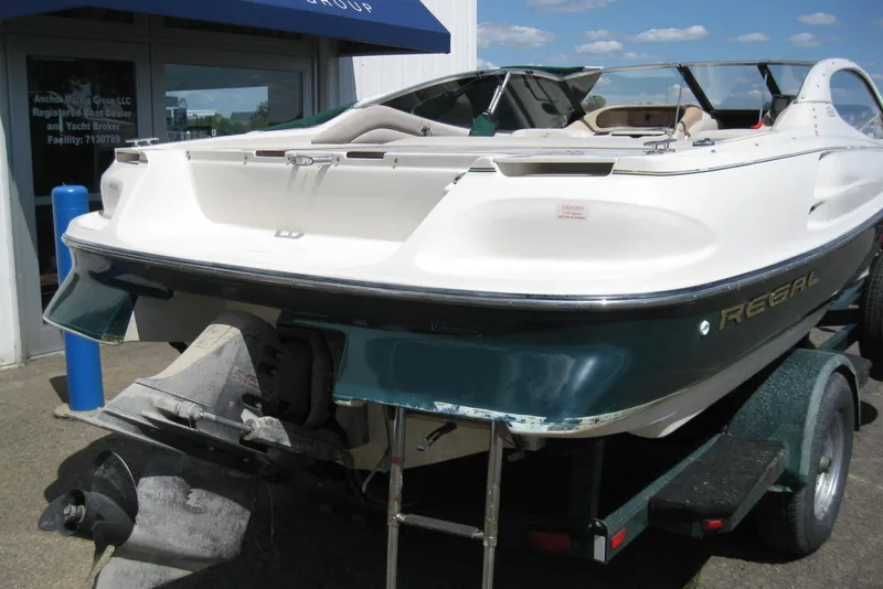 Slide: The Image of 1997 Regal 2100 LSR boat on trailer outside marine dealership. - 5