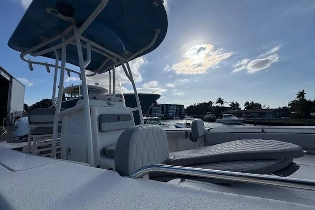 Slide: The Image of 2024 Carolina Skiff 22 Ultra Elite boat docked under a sunny sky. - 12