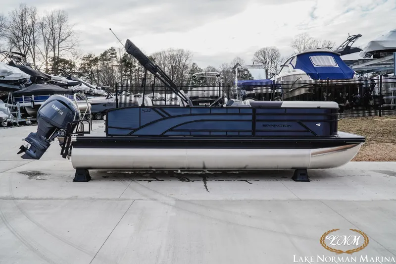 Slide: The Image of 2026 Bennington 22SSB SNAP pontoon boat interior with modern seating and steering console. - 5