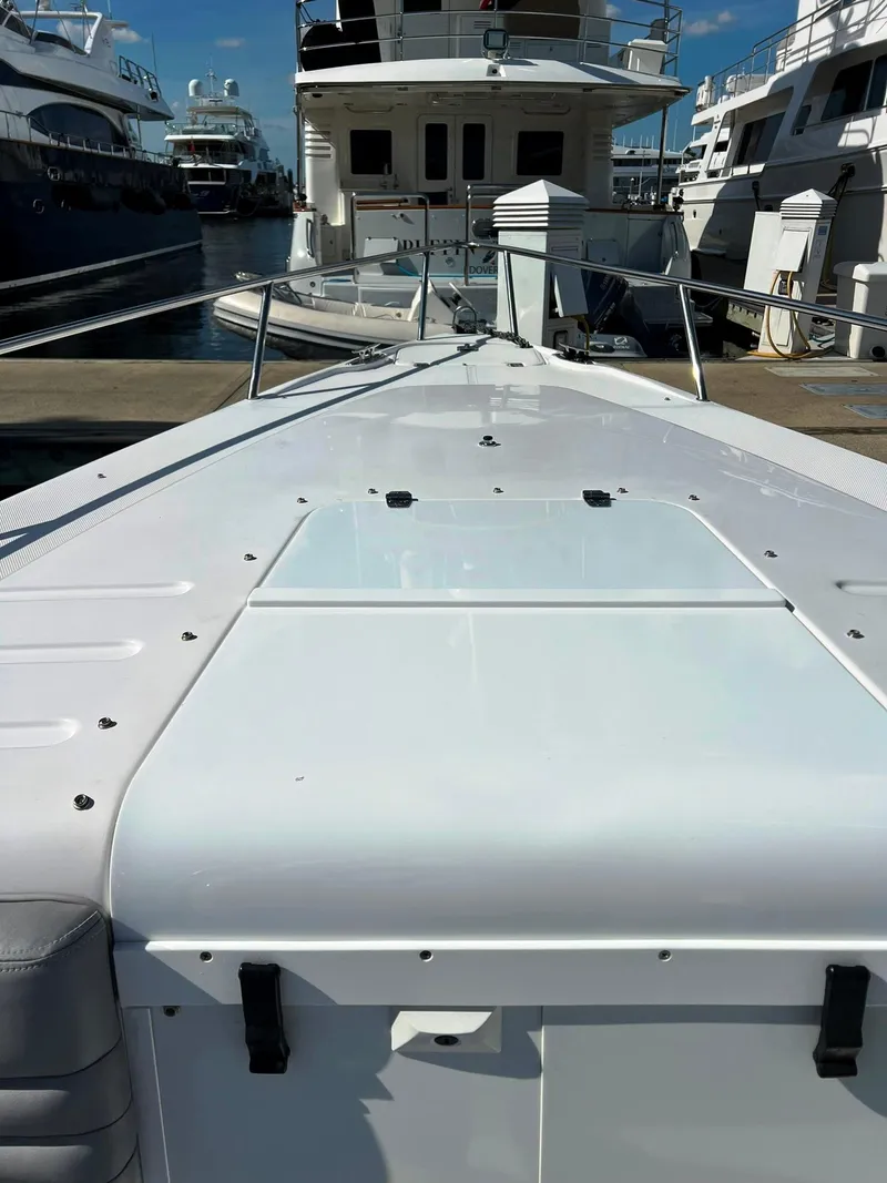 Slide: The Image of 2004 Donzi 35 ZF Cuddy boat docked at marina, view from bow. - 12