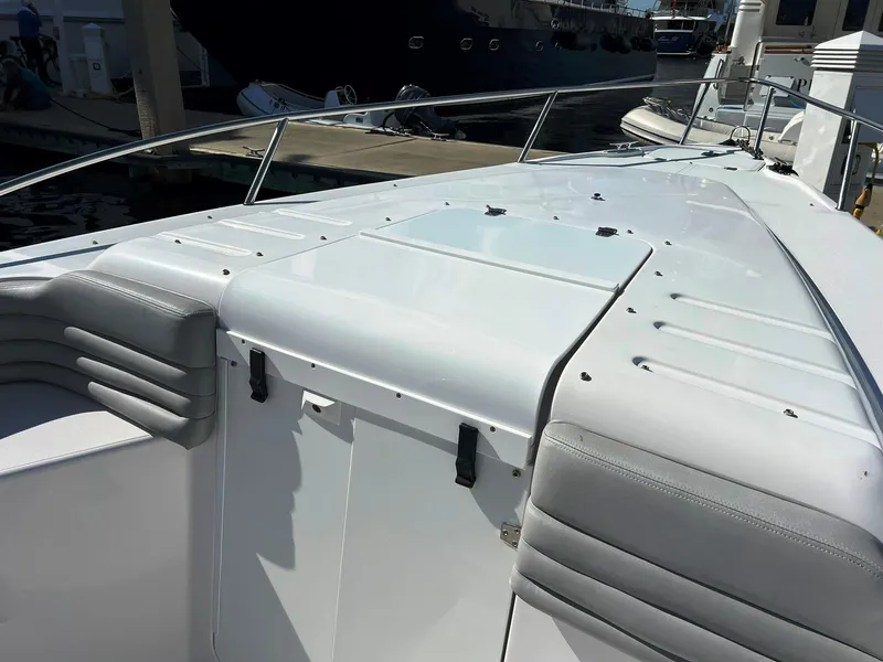 Slide: The Image of 2004 Donzi 35 ZF Cuddy boat deck with sleek white design and cushioned seating. - 13