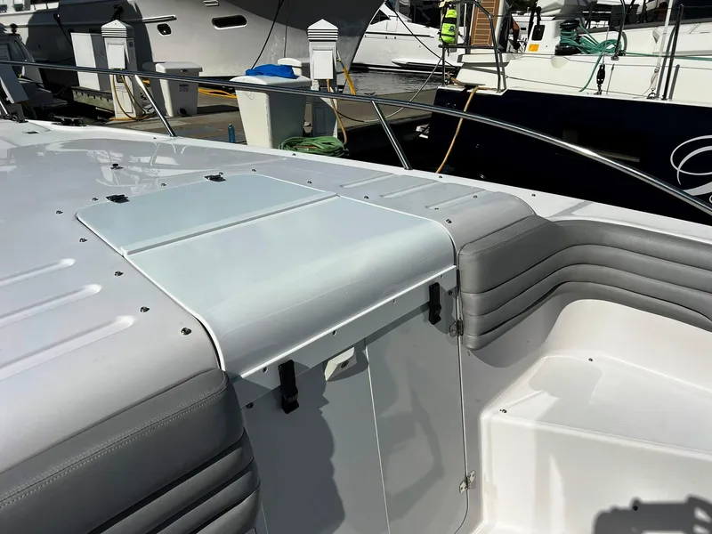 Slide: The Image of 2004 Donzi 35 ZF Cuddy boat interior with sleek seating and storage. - 16