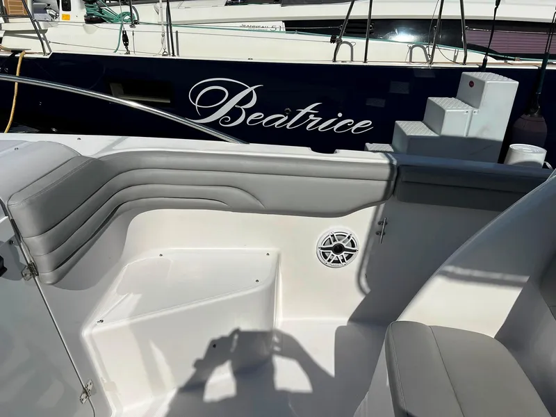 Slide: The Image of 2004 Donzi 35 ZF Cuddy boat interior with seating and speaker, docked near "Beatrice." - 18