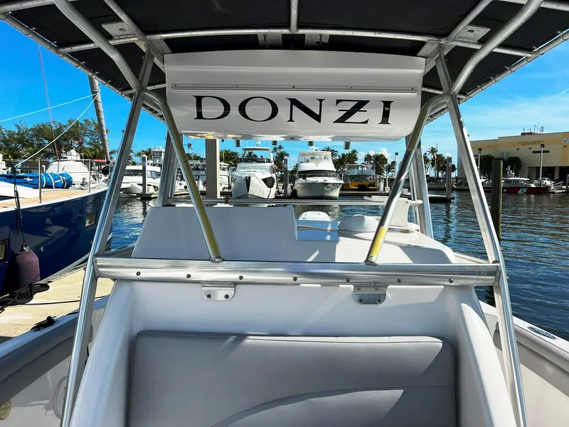 Slide: The Image of 2004 Donzi 35 ZF Cuddy boat interior at marina, showcasing sleek design and comfort. - 20