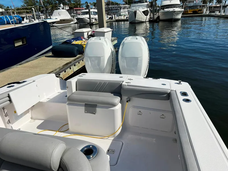 Slide: The Image of 2004 Donzi 35 ZF Cuddy boat docked at marina with twin engines. - 21