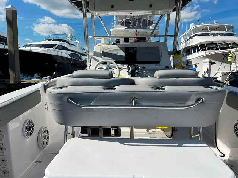 Slide: The Image of 2004 Donzi 35 ZF Cuddy boat interior with helm, docked among yachts. - 22
