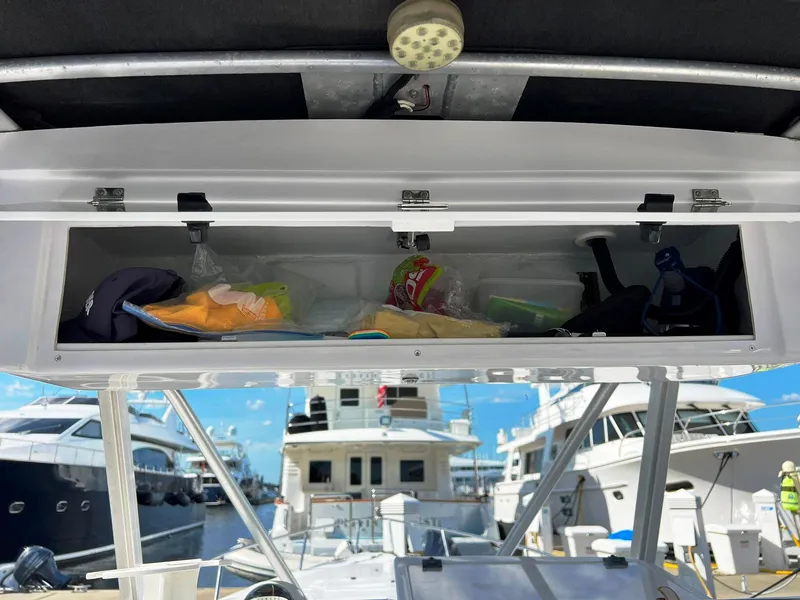Slide: The Image of Open storage compartment on 2004 Donzi 35 ZF Cuddy boat, docked at marina. - 23
