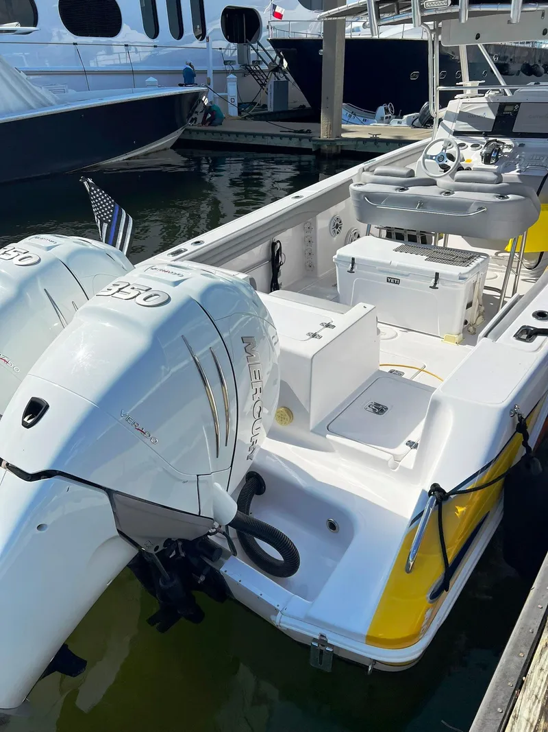 Slide: The Image of 2004 Donzi 35 ZF Cuddy boat with twin engines docked at marina. - 37