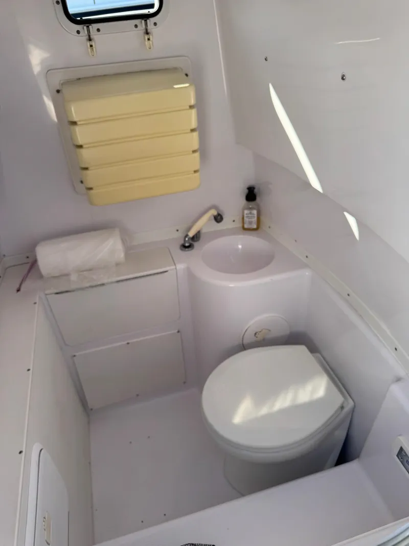 Slide: The Image of 2004 Donzi 35 ZF Cuddy boat bathroom interior with toilet and sink. - 39