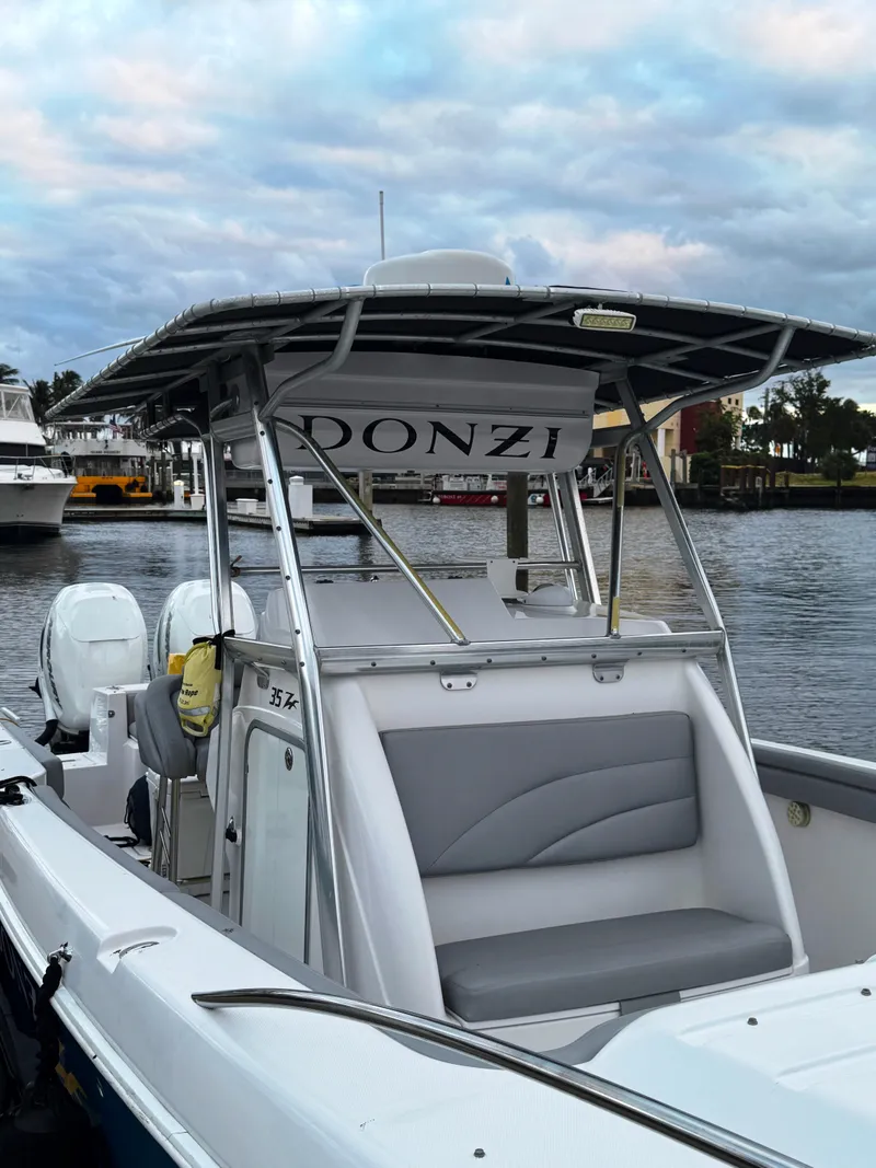Slide: The Image of 2004 Donzi 35 ZF Cuddy boat docked by the waterfront. - 8