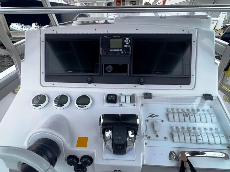 Slide: The Image of 2004 Donzi 35 ZF Cuddy boat dashboard with controls and gauges. - 9