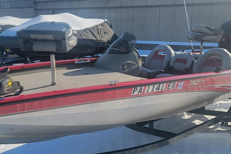 Slide: The Image of 2013 Tracker Pro Team 175 TXW boat with red accents on a snowy surface. - 5