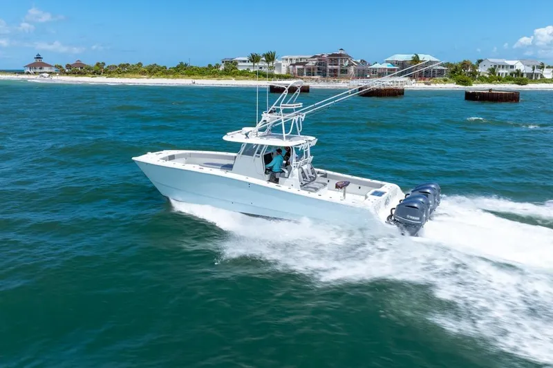 Slide: The Image of 2018 Freeman 37VH boat cruising on blue ocean near a scenic coastline. - 10