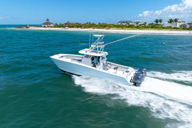 Slide: The Image of Freeman 37VH 2018 boat cruising near a scenic coastline under a clear blue sky. - 11
