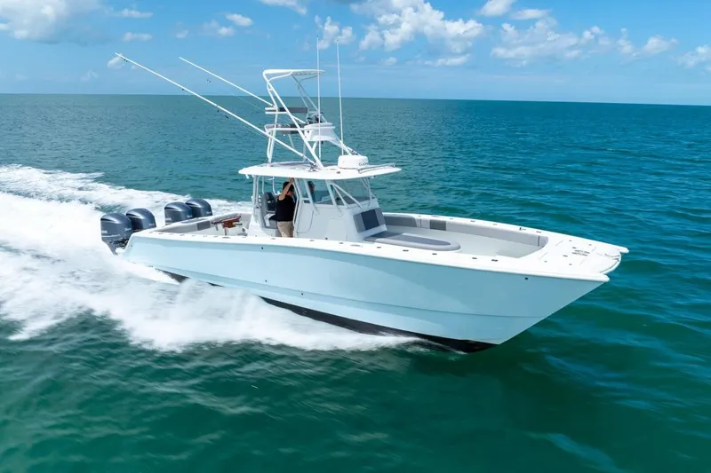 Slide: The Image of 2018 Freeman 37VH boat cruising on open ocean under clear blue sky. - 13