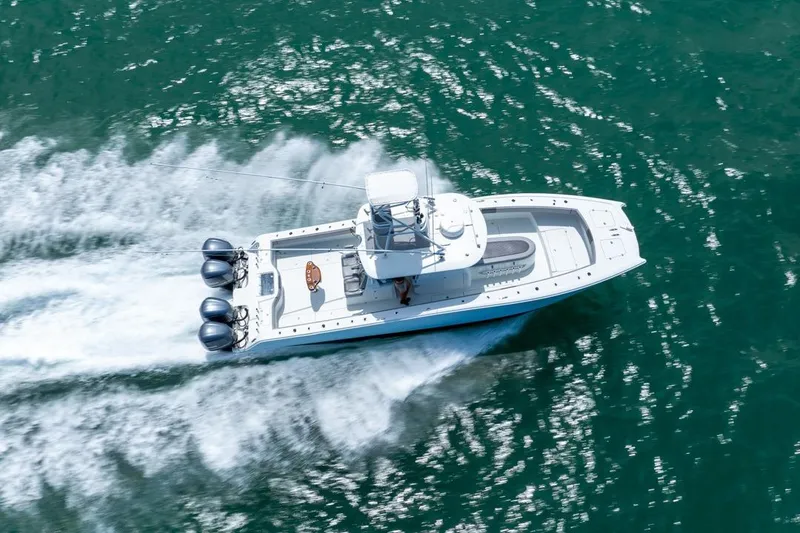 Slide: The Image of Aerial view of 2018 Freeman 37VH boat speeding on turquoise water. - 15