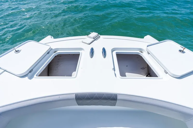 Slide: The Image of 2018 Freeman 37VH boat deck with open storage compartments on blue water. - 19