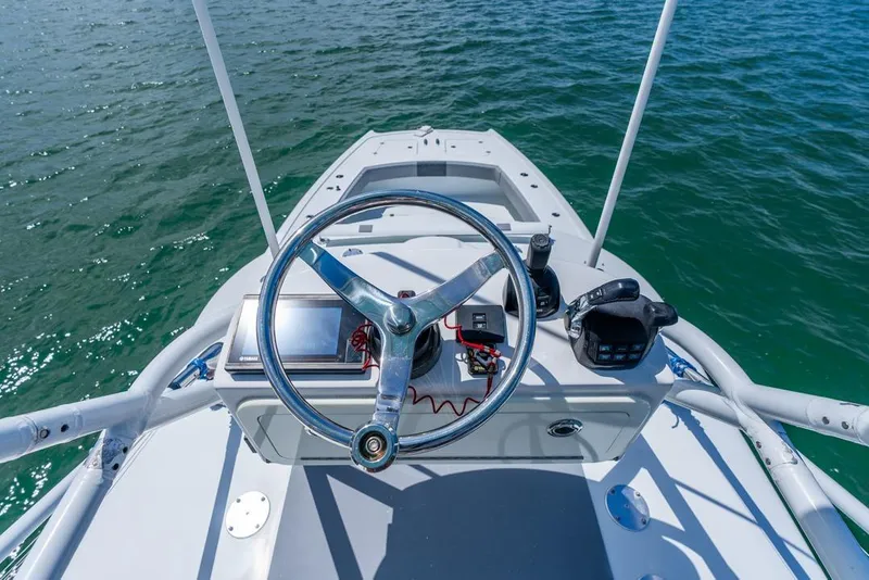 Slide: The Image of Steering console of a 2018 Freeman 37VH boat on open water. - 25