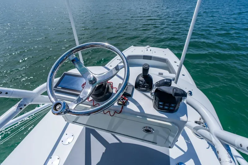 Slide: The Image of 2018 Freeman 37VH boat helm with steering wheel and controls on open water. - 26