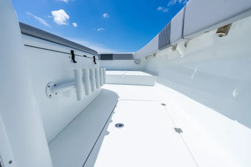 Slide: The Image of 2018 Freeman 37VH boat interior with rod holders under a clear blue sky. - 27