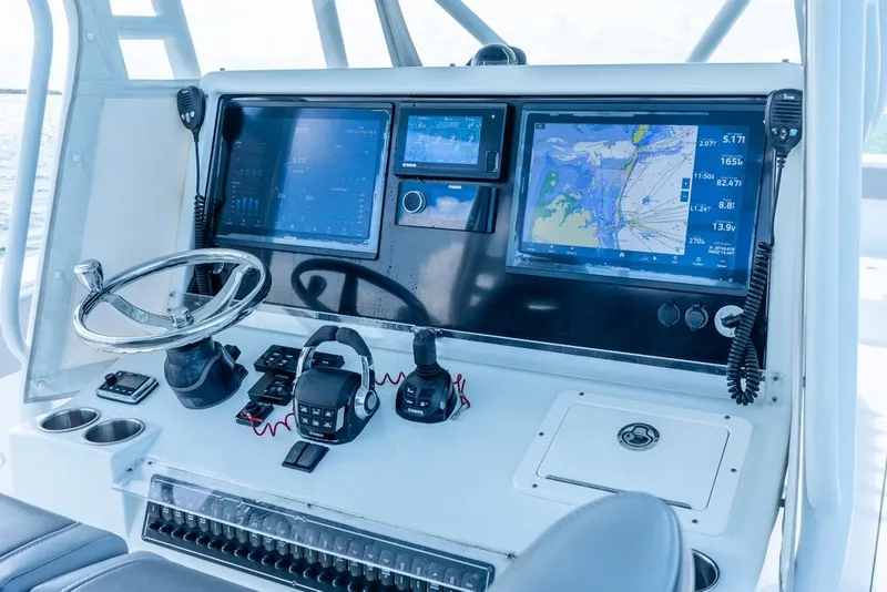 Slide: The Image of Control panel of a 2018 Freeman 37VH boat with navigation screens and steering wheel. - 31