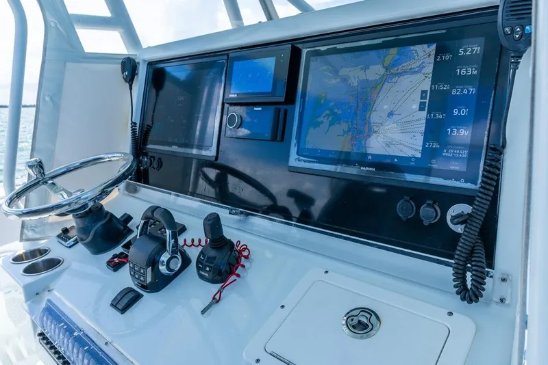 Slide: The Image of Control panel of a 2018 Freeman 37VH boat with navigation screens and steering wheel. - 32
