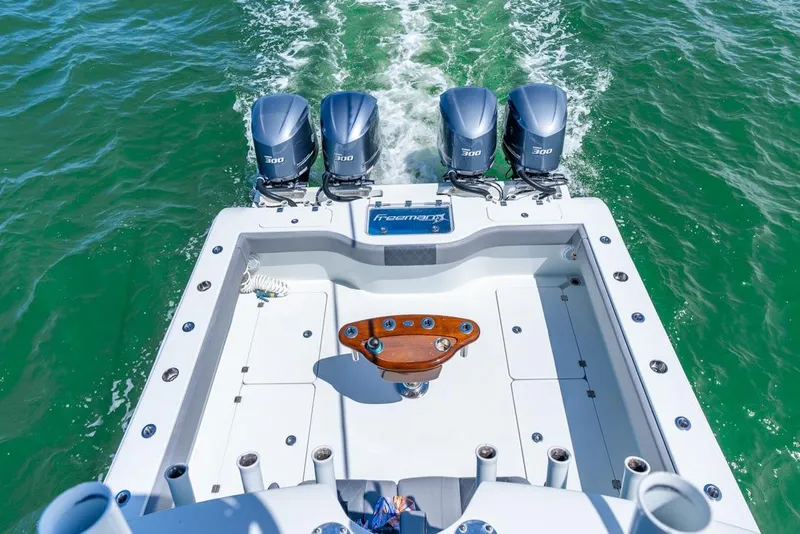 Slide: The Image of Freeman 37VH 2018 boat with four powerful engines cruising on green water. - 41