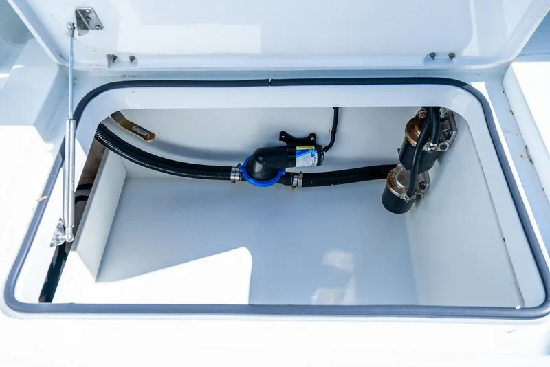 Slide: The Image of Open storage compartment in 2018 Freeman 37VH boat, showing hoses and fittings. - 47